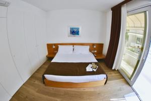 Voodi või voodid majutusasutuse Piccolo Hotel Del Lido toas