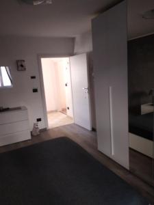 an empty living room with a door and a hallway at Appartamento Caterina in Cairo Montenotte
