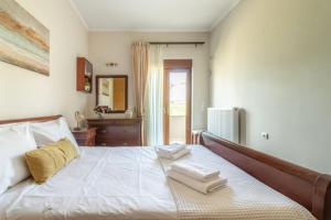 a bedroom with a bed with towels on it at Vacation House close to the Beach in Elia