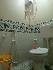 a bathroom with a toilet and a shower at Rudra Villas in Rāmeswaram