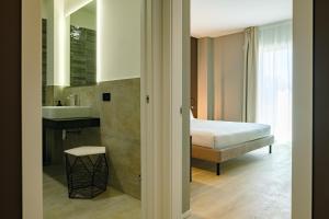 Postel nebo postele na pokoji v ubytování Camoma Aparthotel - Suites Apartments