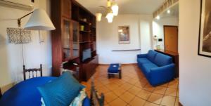 a living room with a blue couch and a table at Talenti house in Rome