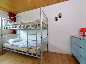a bedroom with two bunk beds and a wooden ceiling at Spacious apartment in Rattlar with private terrace in Willingen