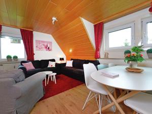 a living room with a table and a couch at Spacious apartment in Rattlar with private terrace in Willingen