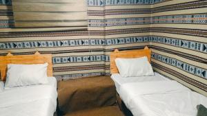 2 Betten in einem Zimmer mit einer Wand in der Unterkunft Dana WhiteDometrail Lodge in Dana