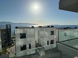 a view of a building with the ocean in the background at SoleMar Suites in Vlorë