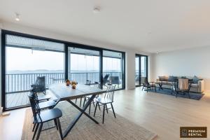 a dining room and living room with a table and chairs at C44 Ultimate Luxury Waterfront Penthouse in Hanko