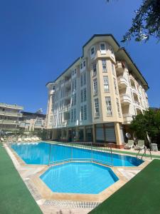 a large building with a swimming pool in front of it at İSABELLA APART OTEL in Alanya