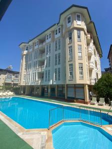a large apartment building with a large swimming pool at İSABELLA APART OTEL in Alanya