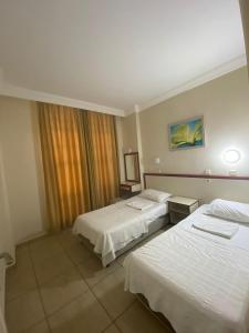 een hotelkamer met 2 bedden en een raam bij İSABELLA APART OTEL in Alanya