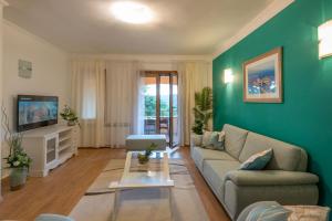 ein Wohnzimmer mit einem Sofa und einem TV in der Unterkunft Villa Tupljak, luxury and comfort in a hidden summer hideout in Gromnik