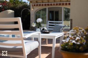 a white table and chairs on a patio at Villa Baladrar by Abahana Villas in Benissa