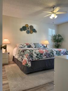 a bedroom with a bed with a floral bedspread at MyCataleya Beautiful Florida Condo (Bradenton) in Bradenton