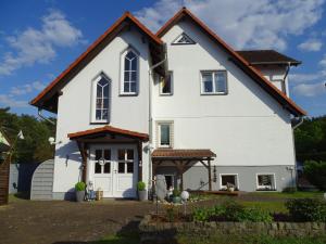 a white house with a red roof at DZ 11 Doppelzimmer in Heringsdorf