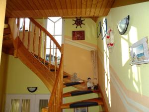a wooden staircase in a room with green walls at DZ 11 Doppelzimmer in Heringsdorf +3 photos