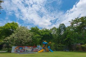 a park with a playground with slides at Radateeree Boutique Resort in Chiang Mai