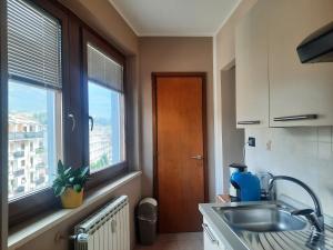 a kitchen with a sink and a window at Appartamento Elisa in Aosta