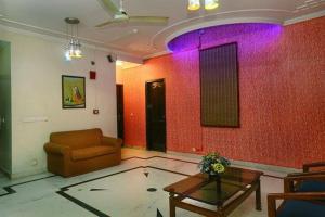 a living room with a couch and a table at Hotel Indraprastha in New Delhi