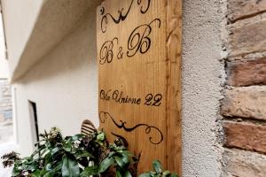 a wooden sign on the side of a building at B&B Vico Suites in Vico nel Lazio