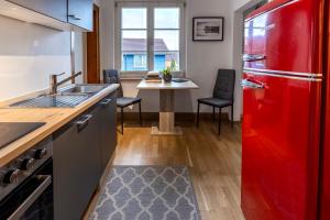 a kitchen with a red refrigerator and a table at Ferienwohnung KARKER 2 in Radolfzell am Bodensee