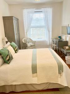a bedroom with a large bed and a window at The Old Post House B&B in St Just