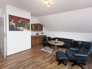 a waiting room with leather chairs and a table at Spacious holiday home in Wildemann with garden in Wildemann