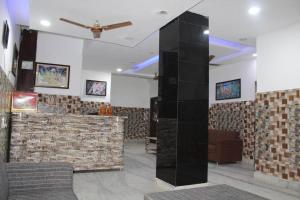 a lobby with a bar and a ceiling fan at Trimrooms @ Katra Railway Station in Katra