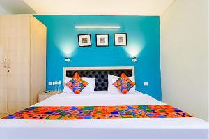 a bedroom with a large bed with a blue wall at Hotel Royal - Near Max Hospital IP Extension in New Delhi