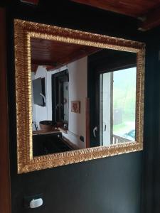 a mirror hanging on a wall in a room at Chalet cima 12 Valle di Sella in Borgo