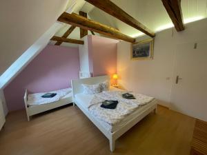 a bedroom with two beds in a attic at Hotel - Ristorante La Grotta in Speyer