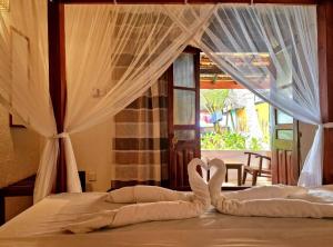 a bed with two swans made out of towels at Panorama Beach Hotel in Tangalle