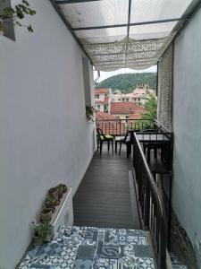 a stairway with a balcony with a table and chairs at Аврамов дом - етаж от къща in Veliko Tŭrnovo
