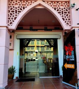 an entrance to a store with a glass door at Uptown Eco Hotel in Kuala Terengganu