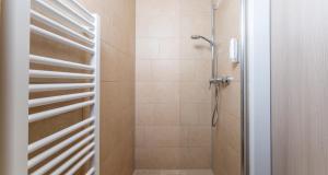 a bathroom with a shower with a glass door at PLAZA INN Bad Rappenau in Bad Rappenau