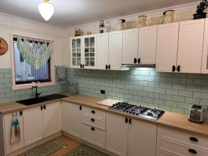 a kitchen with white cabinets and a stove top oven at Lee Manor in Walhalla