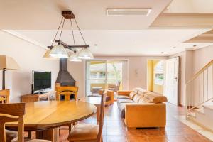 a living room with a table and a couch at Family house on the beach for holidays and temporary workers at Beach Sagunto Valencia in Sagunto