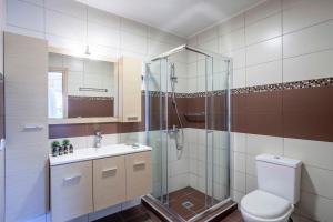 a bathroom with a shower and a toilet and a sink at Seapalm House in Hanioti +37 photos