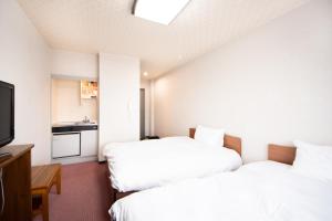 Postel nebo postele na pokoji v ubytování Yamato Saidaiji Hotel SINDAI