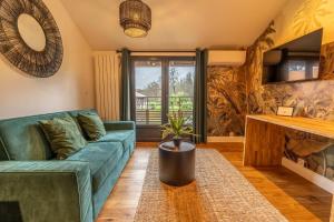 a living room with a couch and a table at Hôtel Quai des Pontis in Cognac