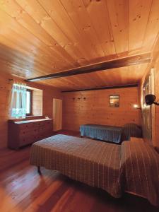 a bedroom with a bed in a wooden cabin at La Casa del Busso in Boccioleto