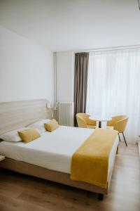 a bedroom with a large bed and a table at Hotel Venezia in Trento