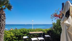 a view of the ocean from a beach with chairs at Superbe Appartement-villa, Palm Beach - Face à la mer in Cannes