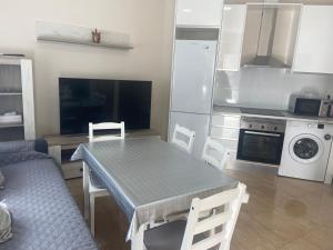 a kitchen with a table and a kitchen with a stove at Casa Valencia in Valencia