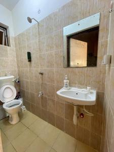 a bathroom with a sink and a toilet at Dasha Studio apartment Bamburi D4 in Bamburi