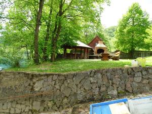a stone wall in front of a house at Nia in Bihać