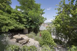 a patio with a table and benches in a garden at Bluestone Cottage Launceston in Launceston