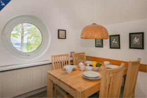 a dining room with a wooden table and a window at Ferienanlage Seeblick Meerchen in Ostseebad Koserow