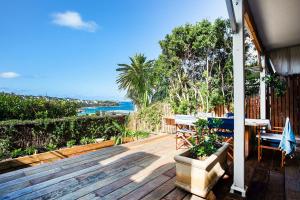 a wooden deck with a table and chairs on it at Barefoot in Bronte IH in Sydney
