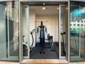 a gym with a treadmill and a bike in a room at City High in Sydney