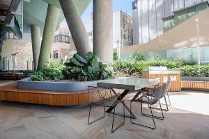 a table and chairs on a patio in a building at City High in Sydney